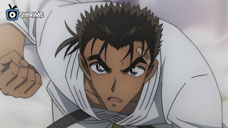 Makoto charging forward in white gi with bandage on cheek, martial artist in top 10 most powerful anime characters according to Japanese fan