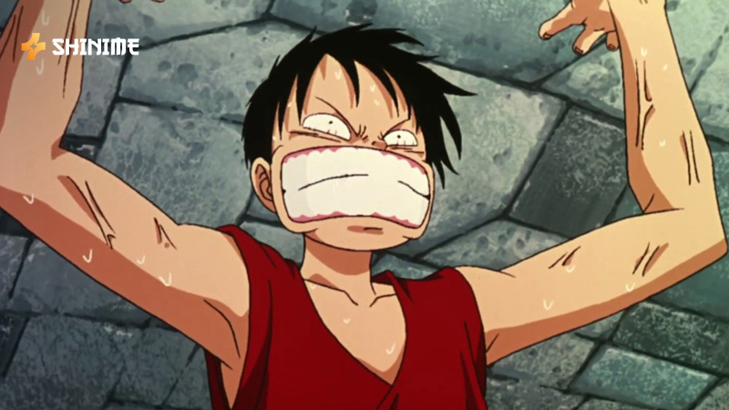 Luffy stretching his arms mid-attack in a battle scene from One Piece Movie 2